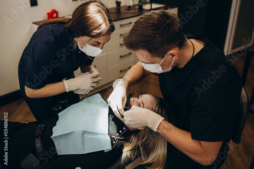 Overview of dental caries prevention.Woman at the dentist's chair during a dental procedure. Beautiful Woman smile close up. Healthy Smile. Beautiful Female Smile