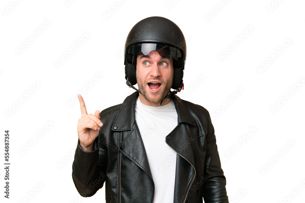 Young caucasian man with a motorcycle helmet isolated on green chroma background intending to realizes the solution while lifting a finger up Young caucasian man with a motorcycle helmet isolated on green chroma background intending to realizes the solution while lifting a finger up