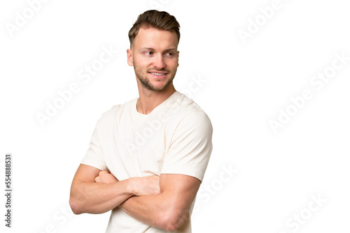 Young blonde caucasian man over isolated background looking to the side and smiling © luismolinero