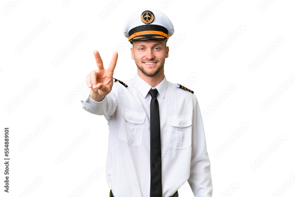 Airplane pilot man over isolated background smiling and showing victory sign