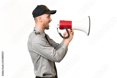 Young security caucasian man over isolated background shouting through a megaphone