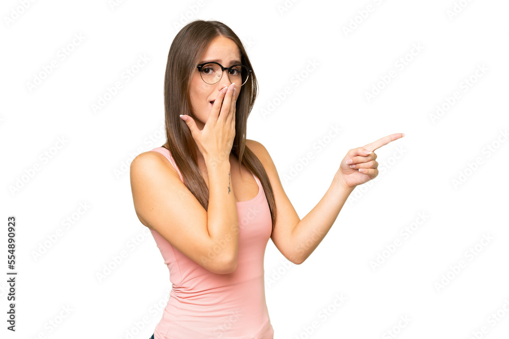 Young pretty caucasian woman over isolated background with surprise expression while pointing side Young pretty caucasian woman over isolated background with surprise expression while pointing side