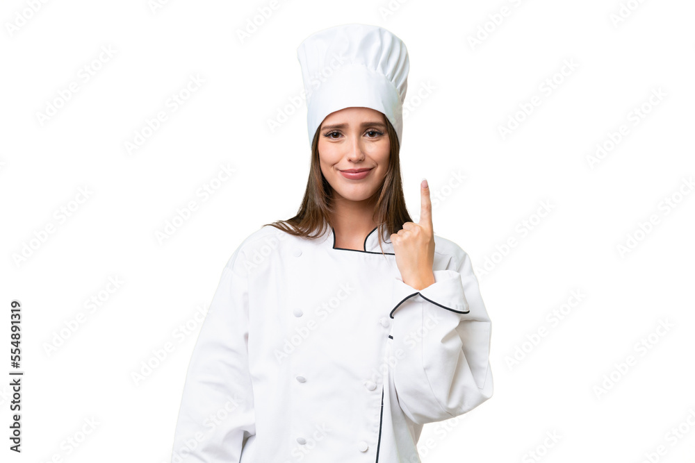 Young chef caucasian woman over isolated background pointing with the index finger a great idea