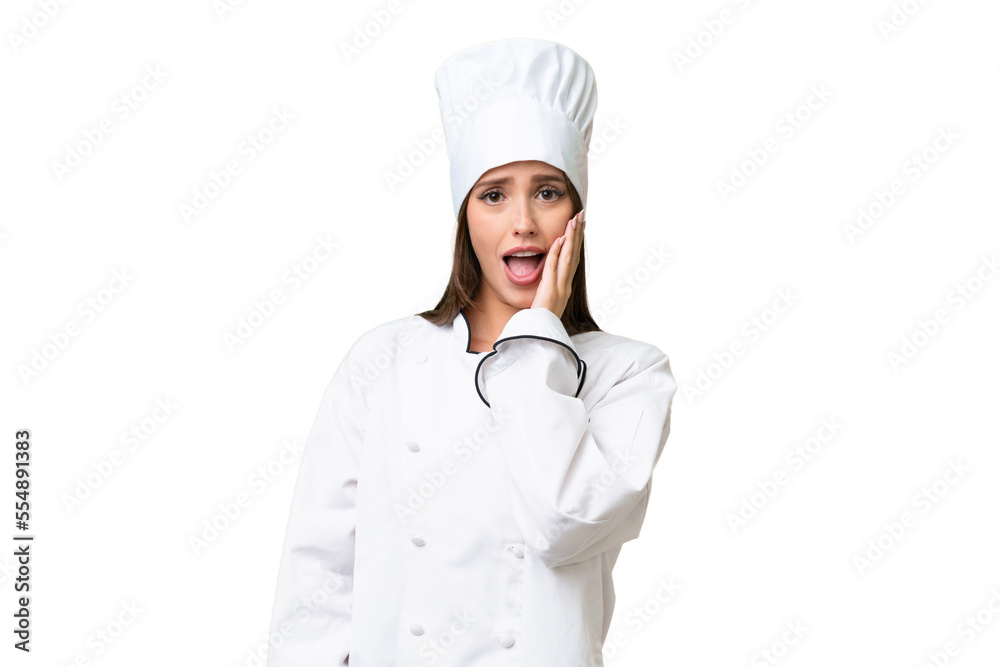 Young chef caucasian woman over isolated background surprised and shocked while looking right Young chef caucasian woman over isolated background surprised and shocked while looking right