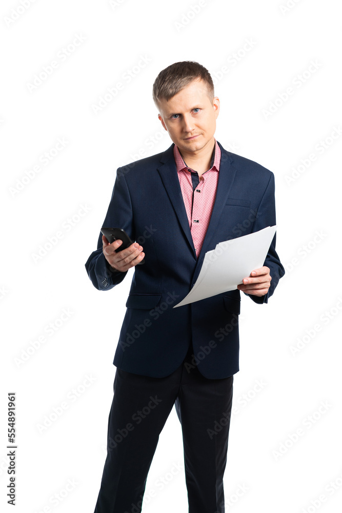 young man in a business suit holds a phone and paper. Business Portner is ready to call you. isolated young man in a business suit holds a phone and paper. Business Portner is ready to call you. isolated