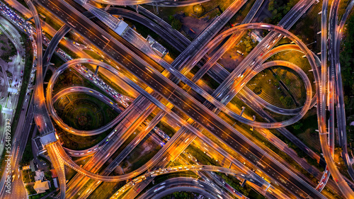 Fotografie, Obraz Aerial view of traffic on massive highway intersection at night.