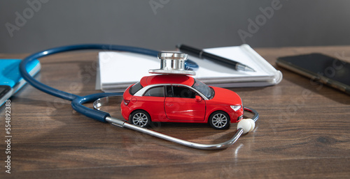 Stethoscope and car model on the table.