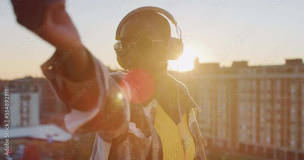 Young Black Woman Dancing on a Roof in Urban Area