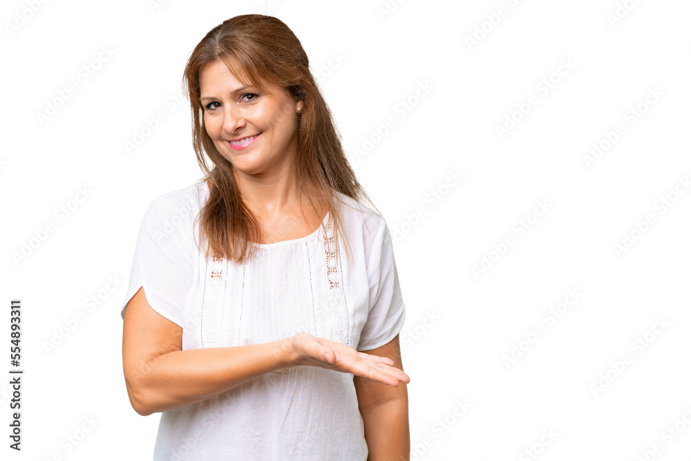Middle-aged caucasian woman over isolated background presenting an idea while looking smiling towards Middle-aged caucasian woman over isolated background presenting an idea while looking smiling towards