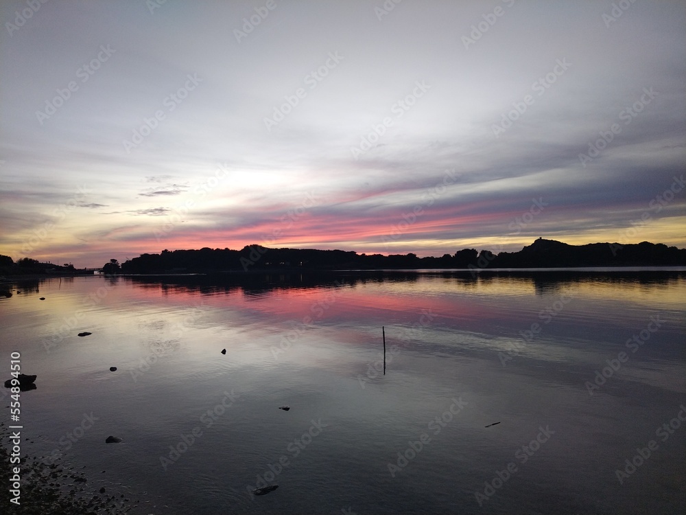 Naklejka premium sunset over the river