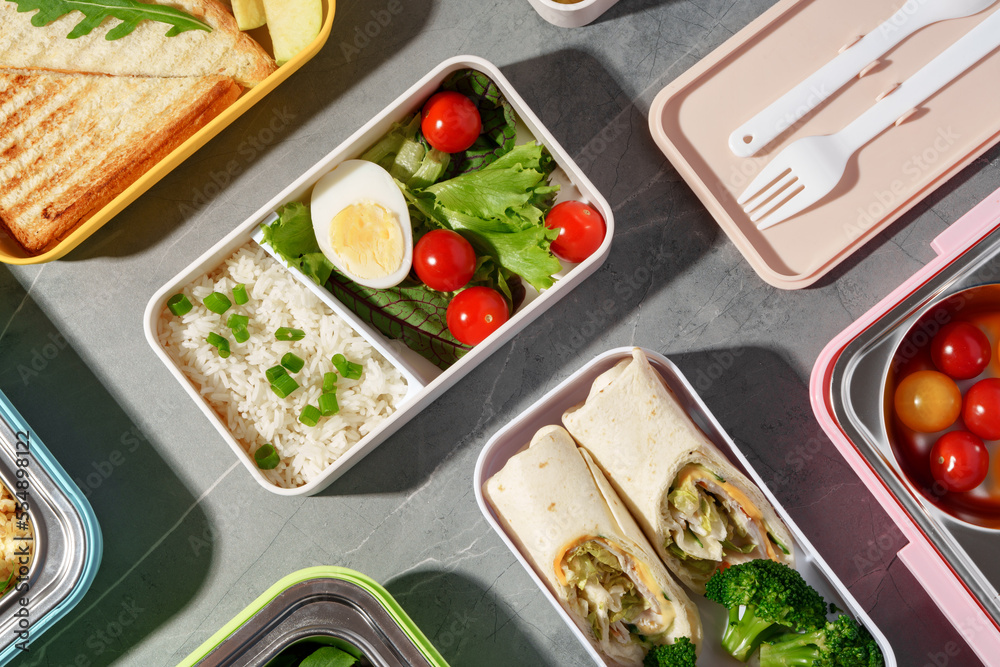 Containers with healthy food on gray background top view. Containers with healthy food on gray background top view.