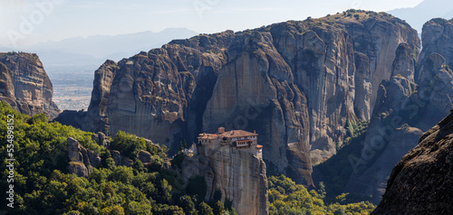 Mountain panorama with Roussanou monastery. Meteora Kalambaka, Thessaly, Greece. Famous Greek orthodox christian shrine, unique rock formation, Unesco world heritage site. Travel, hiking, vacation. photo
