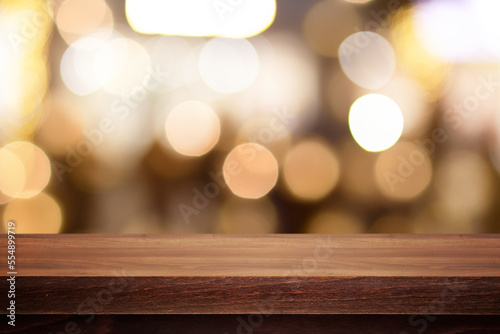 Wooden desk with New Year s or Christmas background and light bulbs. Bokeh or blur background