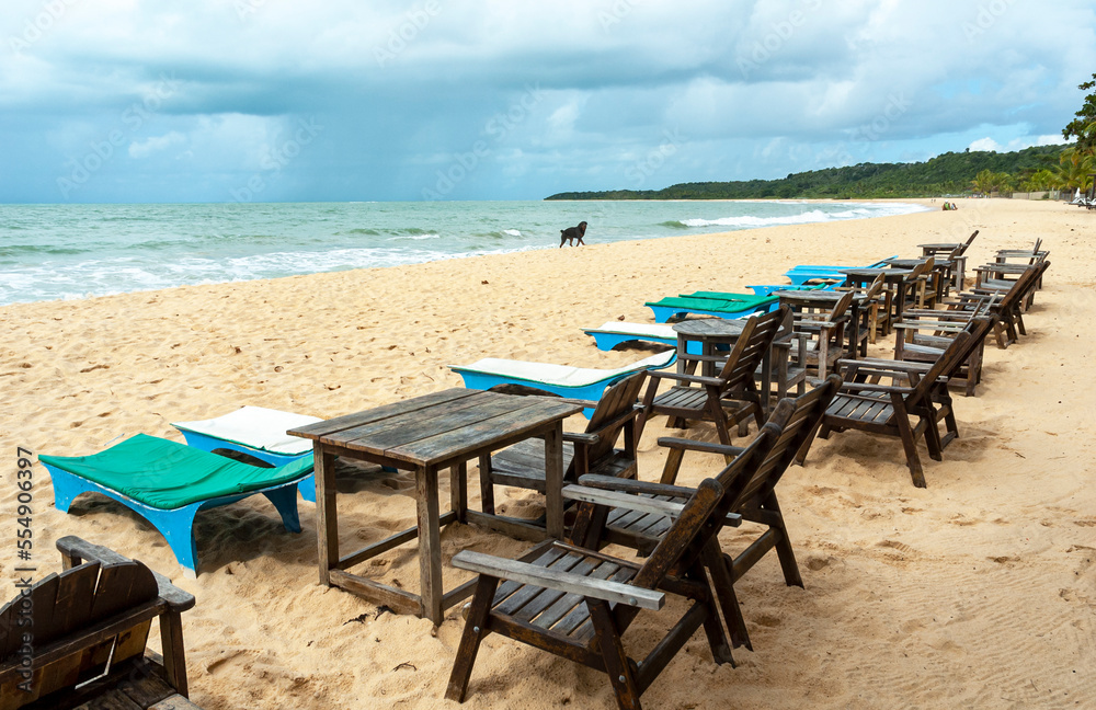 Beautiful maritime panorama of the horizon with cloudy sky on the beach full of beach chairs in the city of Trancoso. Bahia.