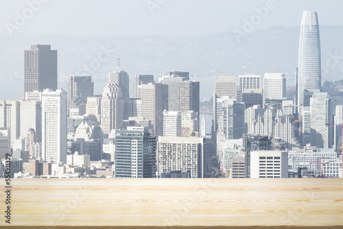 Empty wooden table top with beautiful San Francisco skyscrapers at daytime on background, mock up © Pixels Hunter