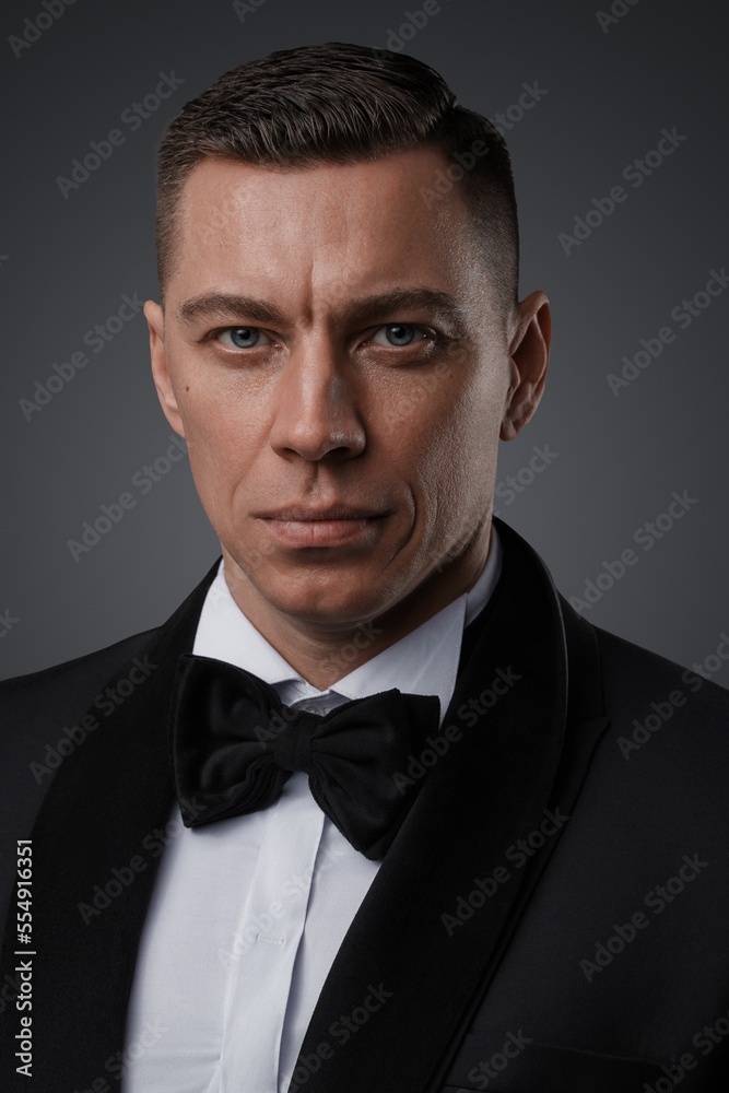 Shot of spy man with bowtie and suit looking at camera. Shot of spy man with bowtie and suit looking at camera.