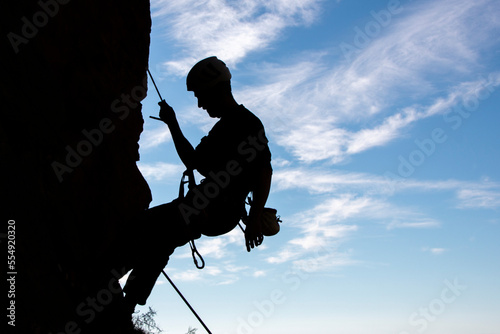 Vertical silhouette of a male climber