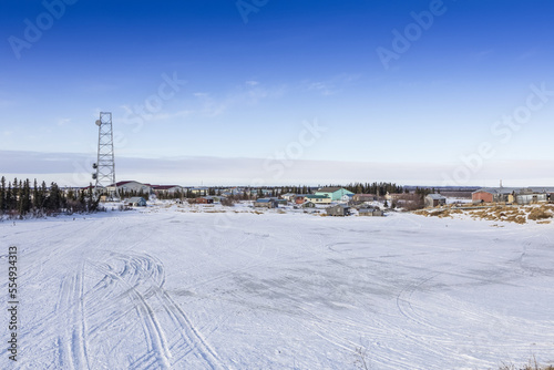 Winter scene of communications tower and village of Noorvik, Alaska; Noorvik, Alaska, United States of America photo