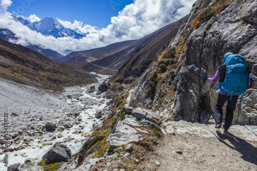 Woman hiking along the Gokyo Trek trail next to Dudh Kosi River, Solokhumbu District, Nepal photo