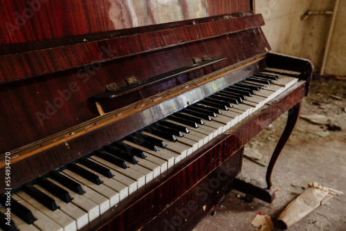 Old piano keyboard in abandoned building. Close up view