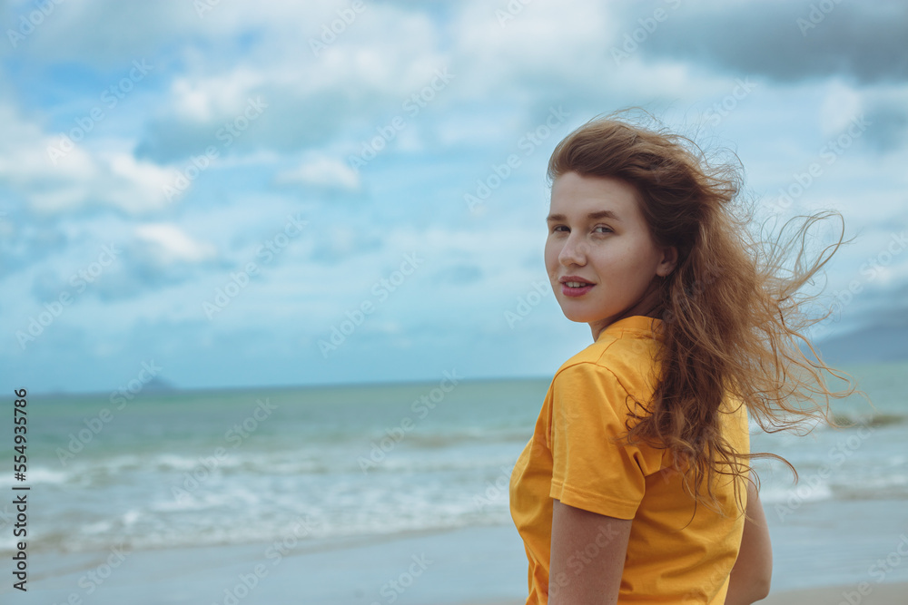 Portrait of happy positive red hair girl, young beautiful carefree woman enjoying summer vacation at sea, beach in exotic tropical country Portrait of happy positive red hair girl, young beautiful carefree woman enjoying summer vacation at sea, beach in exotic tropical country