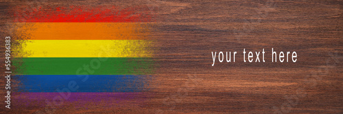 Flag of LGBT. Flag is painted on a wooden surface. Wooden background. Plywood surface. Copy space. Textured background