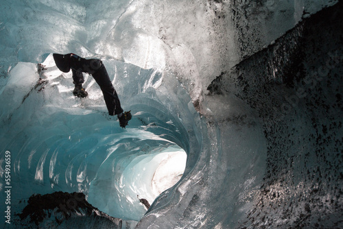 A climber descends by rope into a moulin on Skaftafell Glacier.; Skaftafell National Park, Iceland photo