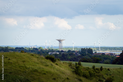 Cityscape with Landskrona water tower and wind turbines seen from Glumslov in Sweden. Selective focus. photo