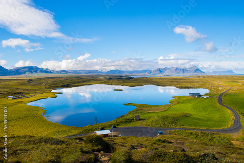 Green Landscape with Lake and Sky with Clouds Beautiful Helgafell, Iceland with Hills and Ocean