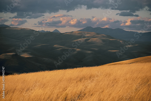 A scenic view of grasslands and mountains near Gunnison, Colorado.; Gunnison, Colorado. photo