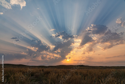 Corpuscular rays during sunrise over the prairies of Saskatchewan; Saskatchewan, Canada