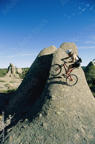 A mountain biker on a rock formation in the Sierra Madres.; Greel, Mexico. photo