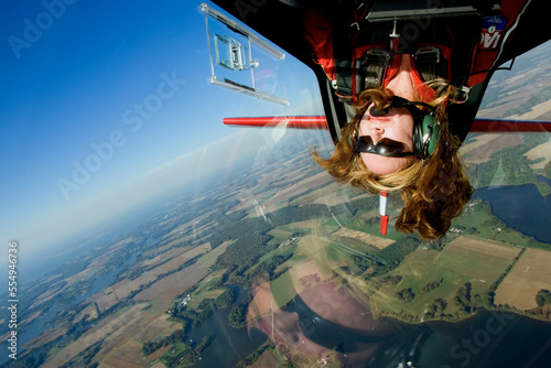 A female aerobatic pilot flies upside down.; Eastern Shore of Maryland. photo