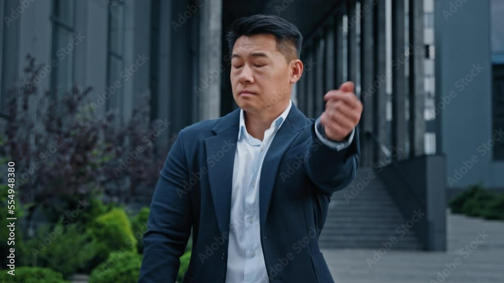 Worried sad middle-aged man in city waiting meeting check late time looking around. 40s Asian Korean businessman outdoors look at wristwatch waiting taxi meet business partner worry about lateness Worried sad middle-aged man in city waiting meeting check late time looking around. 40s Asian Korean businessman outdoors look at wristwatch waiting taxi meet business partner worry about lateness