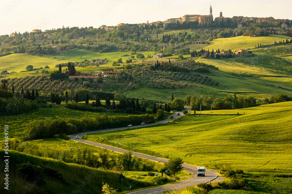 Vehicles drive along winding roads through the hillsides of Pienza, Italy; Pienza, Tuscany, Italy Vehicles drive along winding roads through the hillsides of Pienza, Italy; Pienza, Tuscany, Italy
