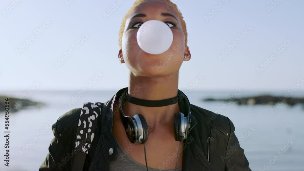 Young black woman, face and bubble gum outdoor at beach, travel and holiday in Atlanta. Chewing gum bubbles, sweets and candy at ocean with playful, funny and happy gen z girl, happiness and freedom Young black woman, face and bubble gum outdoor at beach, travel and holiday in Atlanta. Chewing gum bubbles, sweets and candy at ocean with playful, funny and happy gen z girl, happiness and freedom