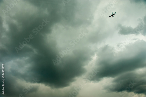 Plane flies under cloud cover as it nears for landing; Chantilly, Virginia, United States of America photo