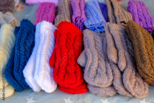 knitted warm gloves for winter in different colors. handicraft