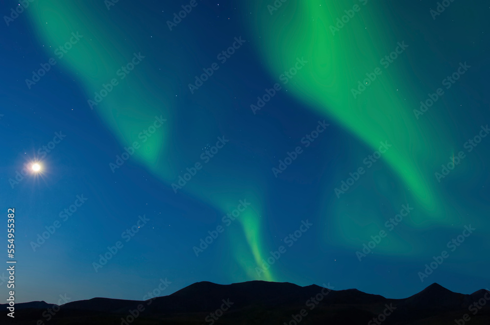 Full moon and Northern Lights put on a magical and mystical display in the night sky, Arctic National Wildlife Refuge; Alaska, United States of America Full moon and Northern Lights put on a magical and mystical display in the night sky, Arctic National Wildlife Refuge; Alaska, United States of America