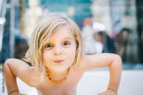 Girl looking mischievous at the camera. photo