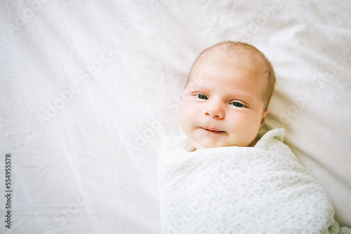 Newborn baby on a bed. photo