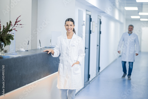 Doctors in lab coats in the clinic corridor