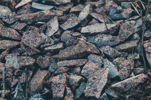 Gray small rocks ground texture. black small road stone background. gravel pebbles stone seamless texture. dark background of crushed granite gravel, close up. clumping clay