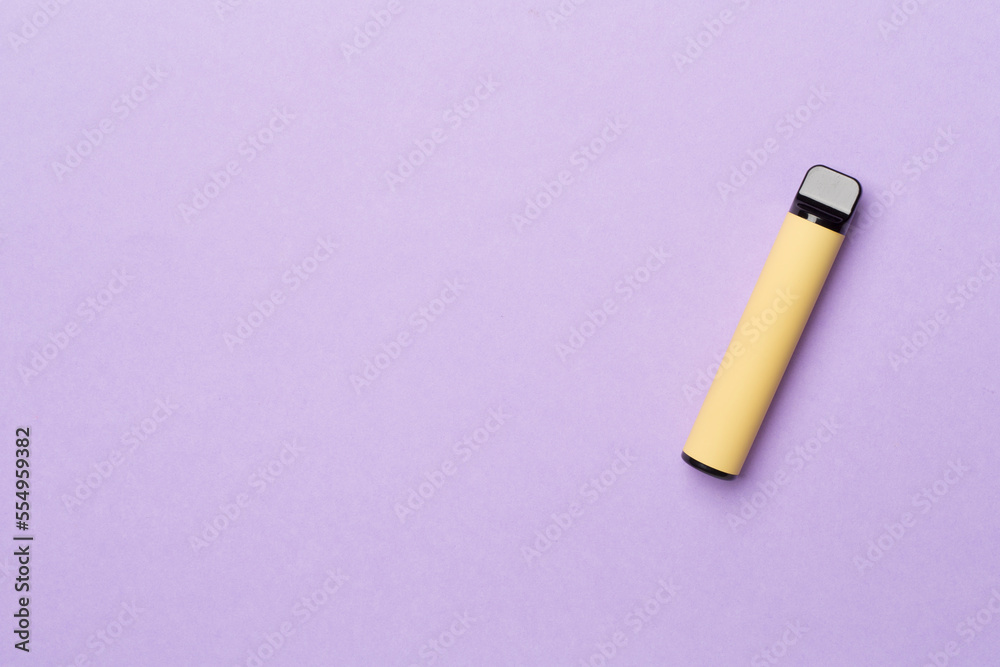 Disposable electronic cigarette on color background, top view Disposable electronic cigarette on color background, top view