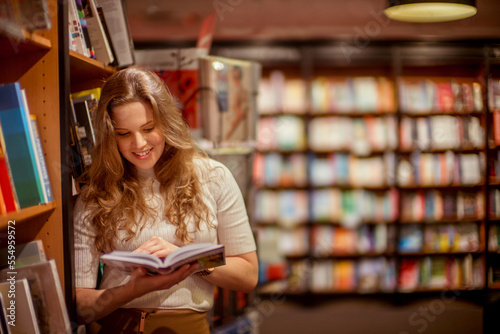 A young woman browses in a book store. photo
