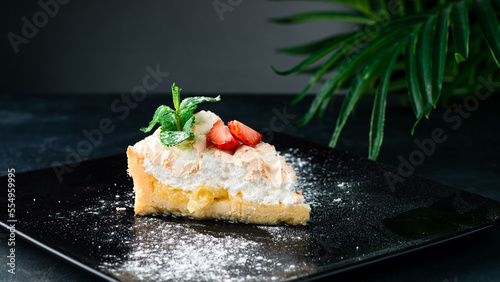 Piece of cake with meringue, fresh strawberries and mint. photo