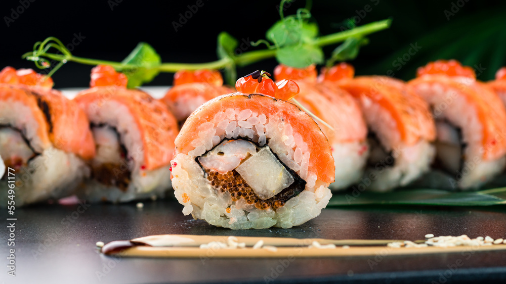 Sushi rolls with smoked salmon, shrimp, flying fish roe, rice and nori. Sushi rolls with smoked salmon, shrimp, flying fish roe, rice and nori.