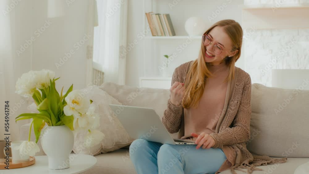 Caucasian happy successful winner woman in eyeglasses girl lady female celebrate achievement amazing result at apartment couch with laptop app approved offer opportunity win bet bid success winning Caucasian happy successful winner woman in eyeglasses girl lady female celebrate achievement amazing result at apartment couch with laptop app approved offer opportunity win bet bid success winning