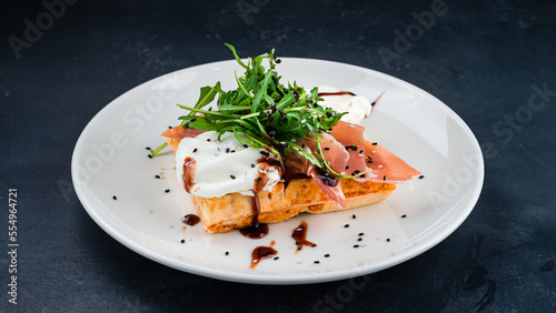 Viennese waffles with Parma ham, poached egg, cream cheese, arugula and sauce.