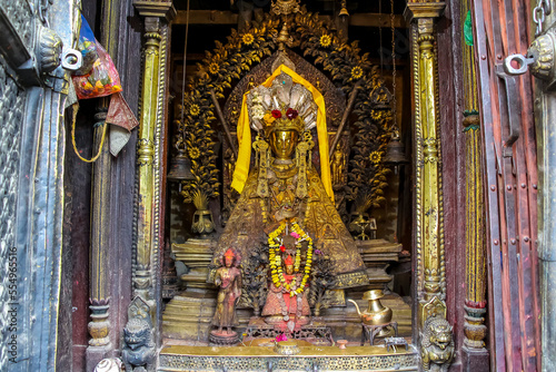 Small old golden Buddha statue in Yashodhar Mahabihar buddhist temple in Lalitpur city, Nepal. Religious symbols theme.